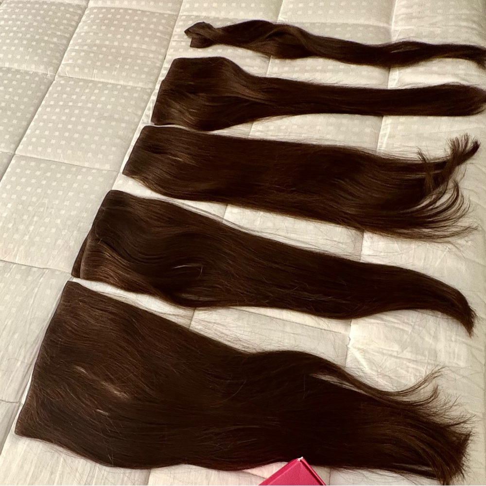 Rich human hair, dark brown extensions.